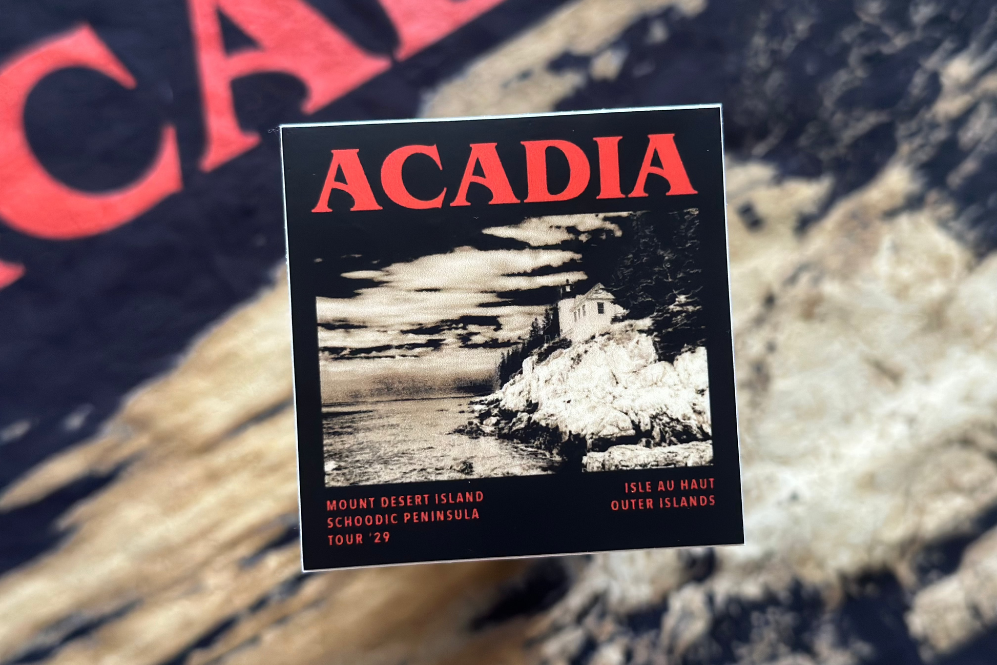 Acadia National Park sticker with scenic image and text on a blurred background