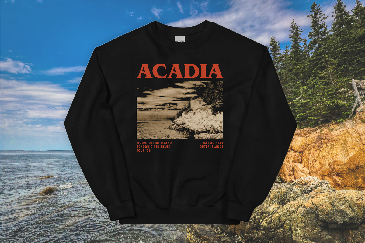 Black sweatshirt with 'ACADIA' text and nature graphic against a scenic background