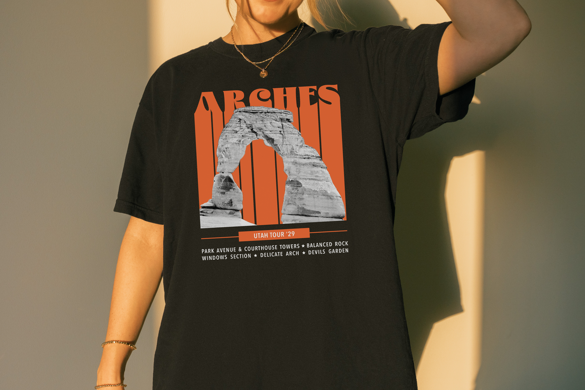 Person wearing a black t-shirt with Arches National Park graphic design.
