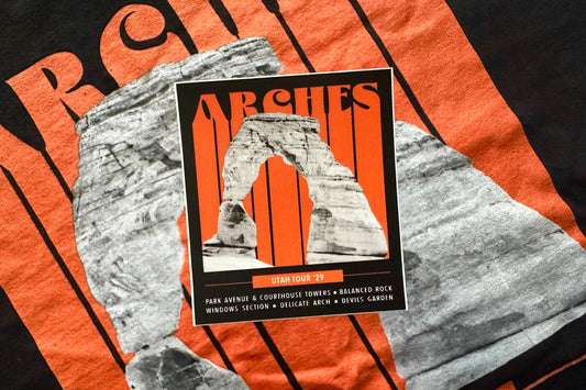Sticker with 'Arches' National Park graphic design featuring orange and black colors.