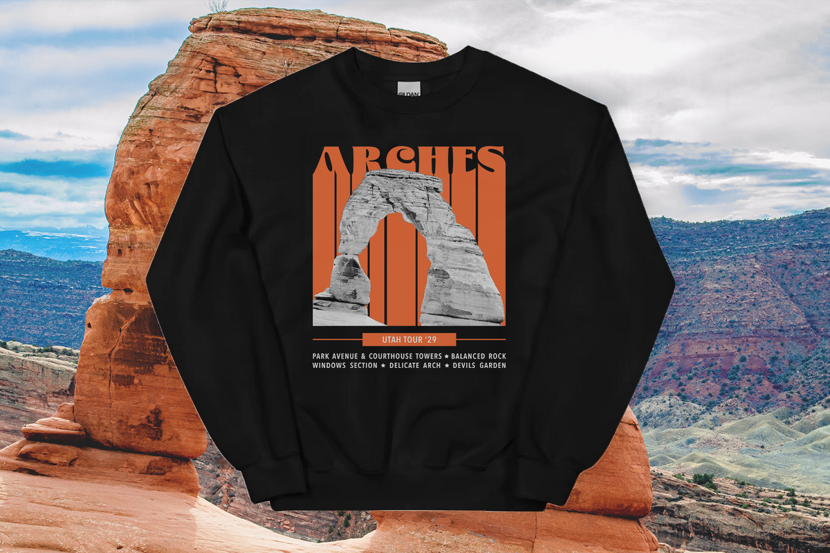 Black sweatshirt with Arches National Park design on a rock formation with desert landscape in the background