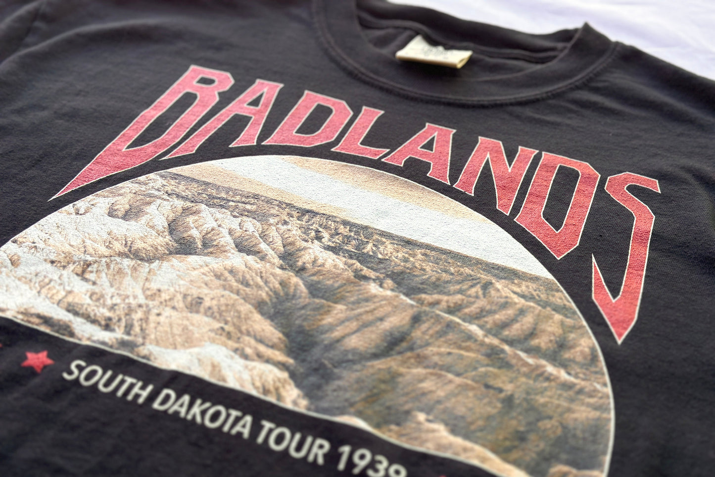 Black t-shirt with 'Badlands' graphic and text on a plain background