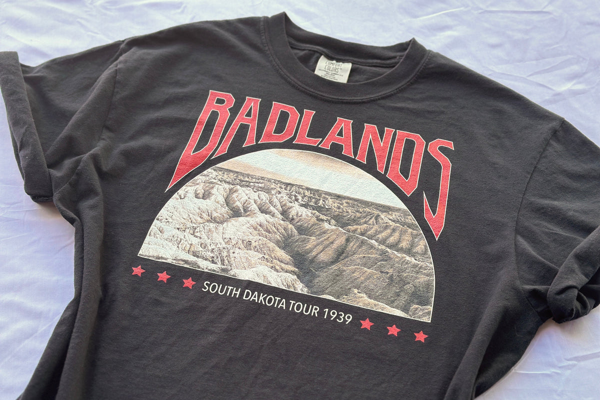 Black t-shirt with 'Badlands' graphic and text on a white background