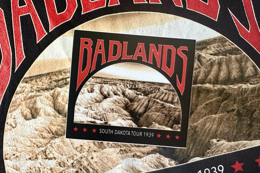 Sticker with a red and white 'Badlands' graphic design, on a texture background