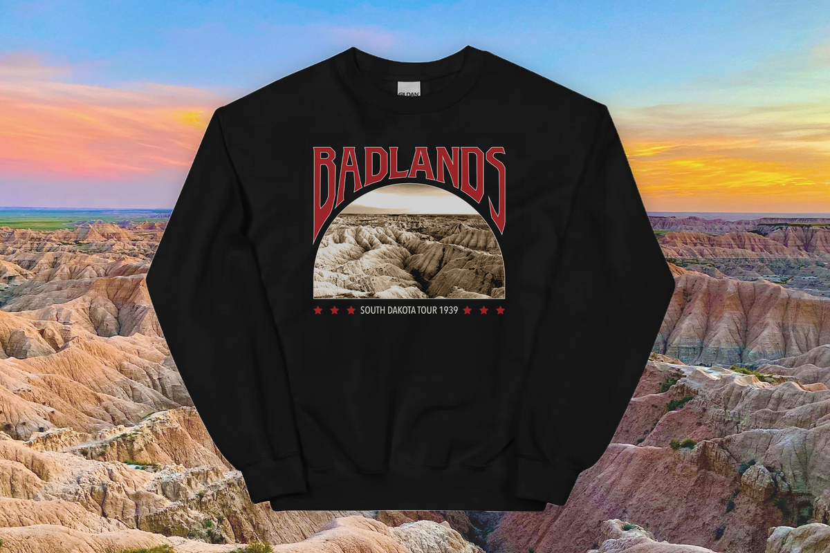 Black sweatshirt with 'Badlands' graphic design against a Badlands National Park backdrop