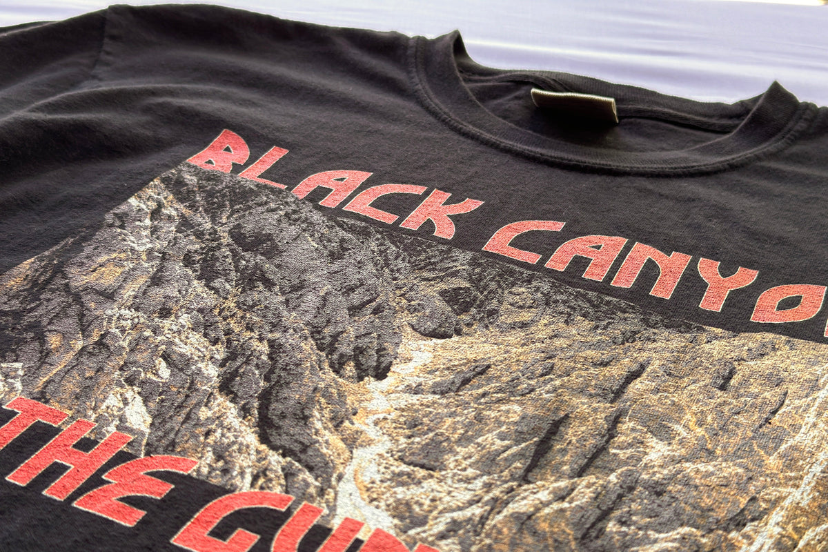 Black t-shirt with red text 'Black Canyon' and mountain graphic