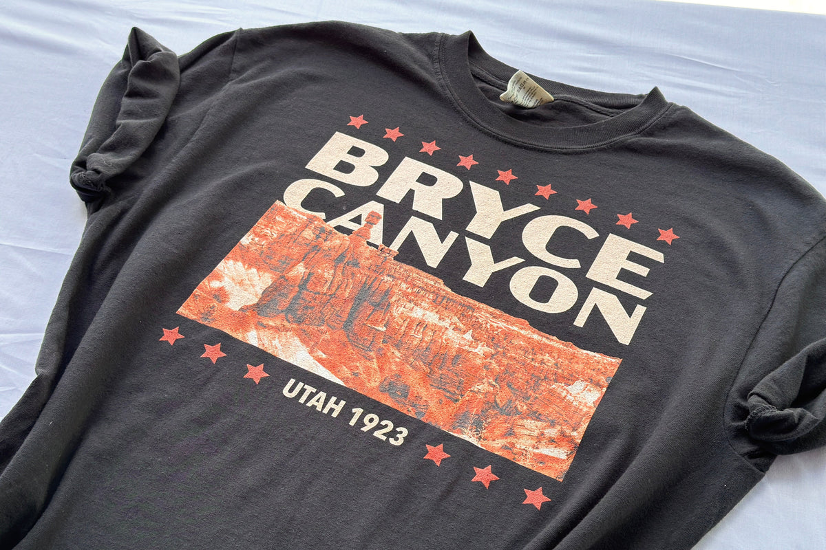 Black t-shirt with Bryce Canyon design on a light gray background