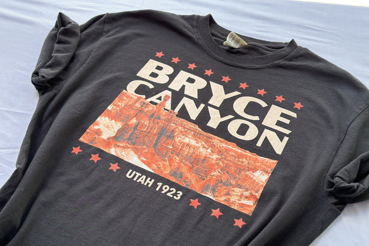 Black t-shirt with Bryce Canyon design on a light gray background