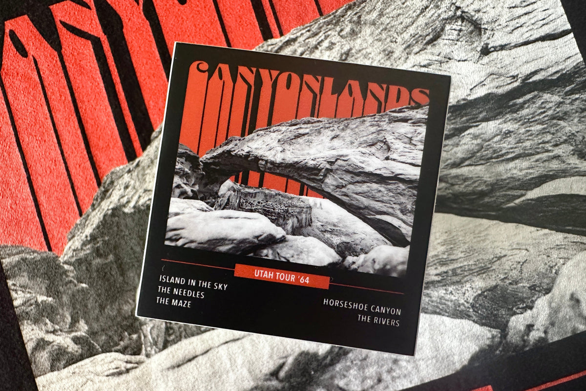 Sticker with an orange and white 'Canyonlands' graphic design, on a textured background