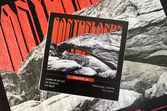 Sticker with an orange and white 'Canyonlands' graphic design, on a textured background