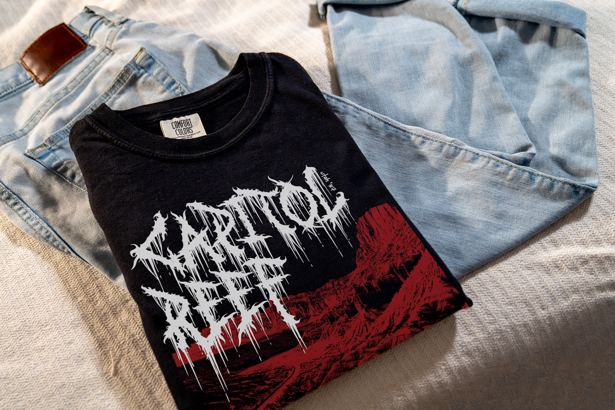 Black t-shirt with white and red 'Capitol Reef' graphic design on a light blue denim jacket