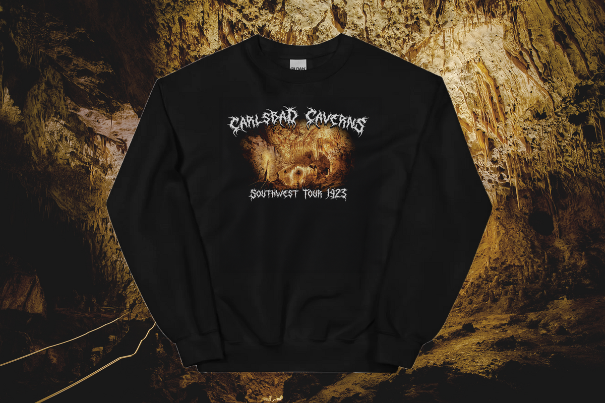 Black sweatshirt with 'Carlsbad Caverns' graphic design and text on a textured brown background