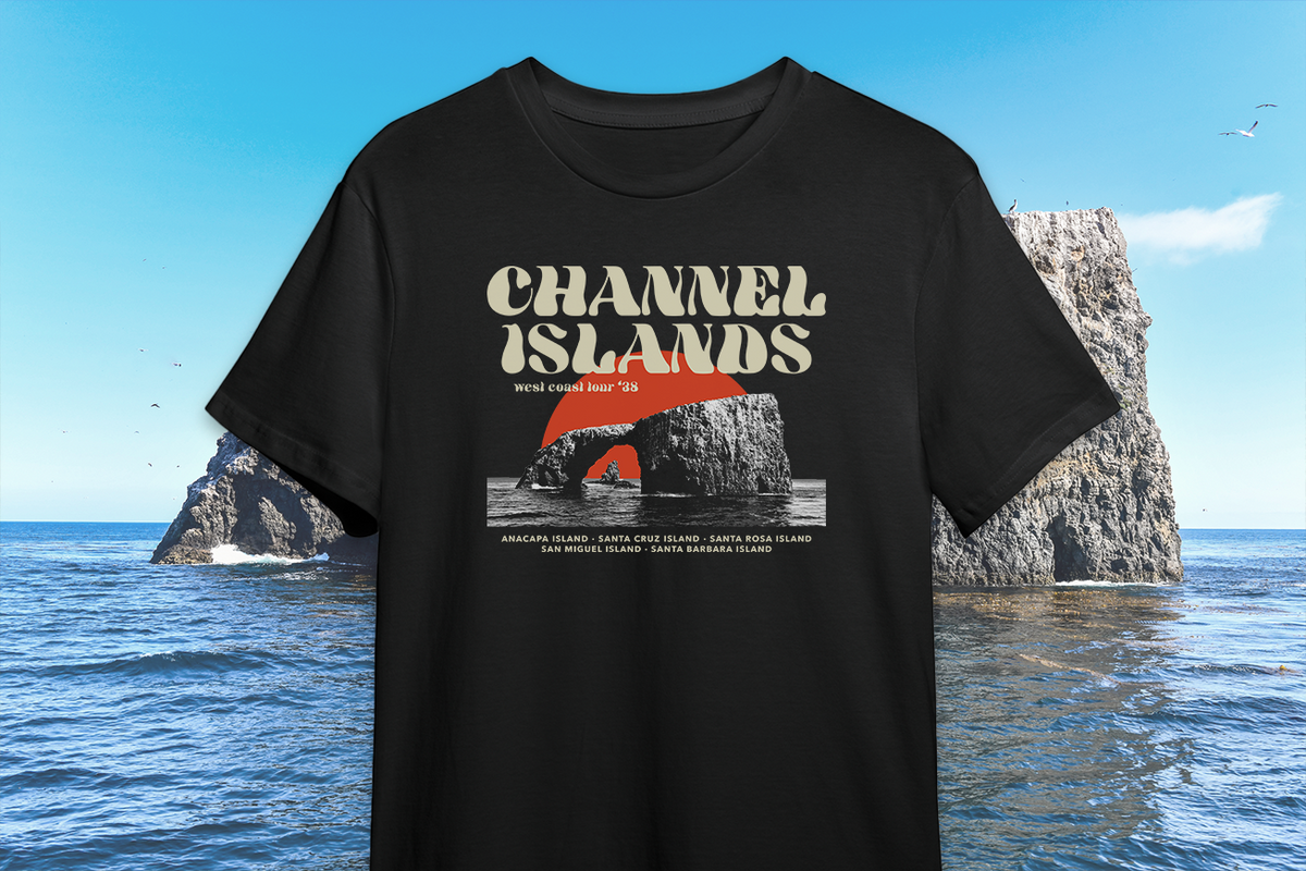 Black t-shirt with 'Channel Islands' design in front of a rocky island and ocean.