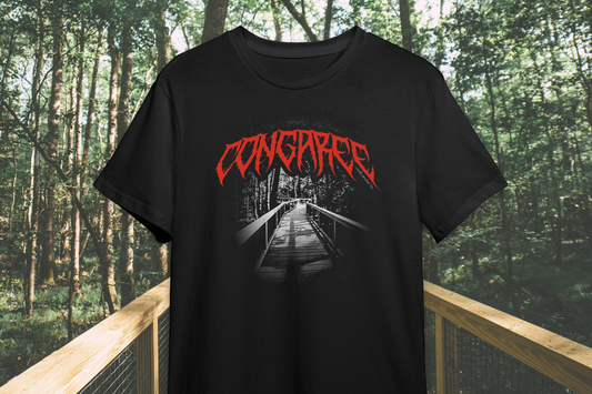 Black t-shirt with red text 'Congaree' displayed outdoors on a wooden bridge.