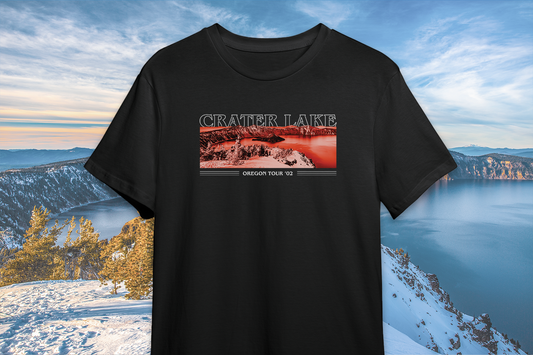 A black t-shirt with 'CRATER LAKE' printed on the front, featuring a landscape image of Crater Lake