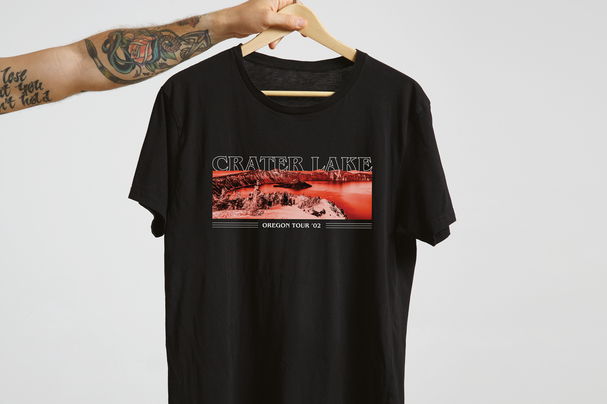 Black t-shirt with 'Crater Lake' graphic design on a hanger against a white background