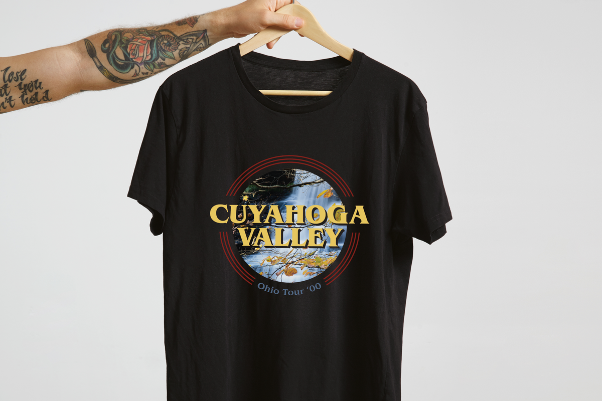 Black t-shirt with 'Cuyahoga Valley' graphic design on a hanger against a light gray background.