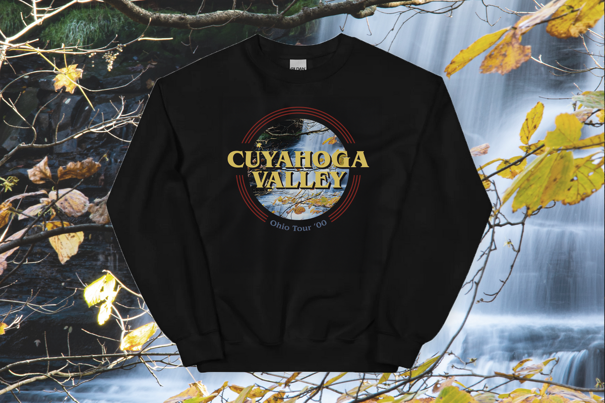 Black sweatshirt with 'Cuyahoga Valley' design against a nature-themed background