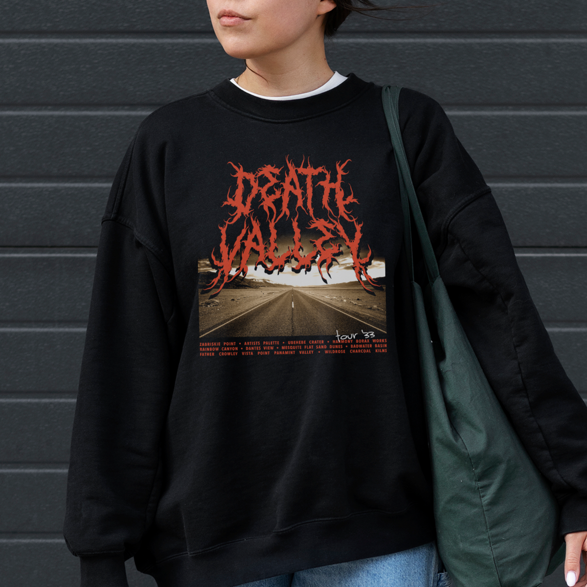 A woman wearing a black sweatshirt with a red and white 'Death Valley' graphic