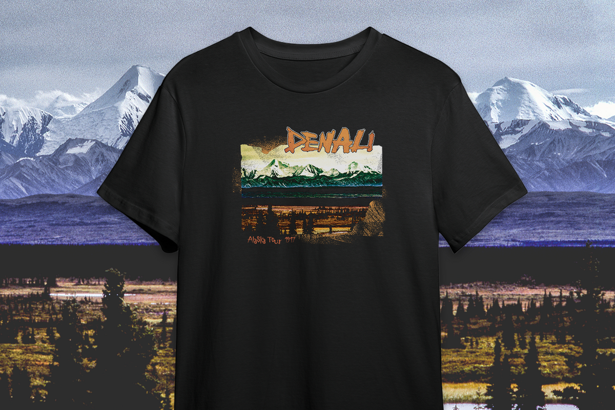 Black t-shirt with a mountain graphic and 'Denali' text against a scenic background
