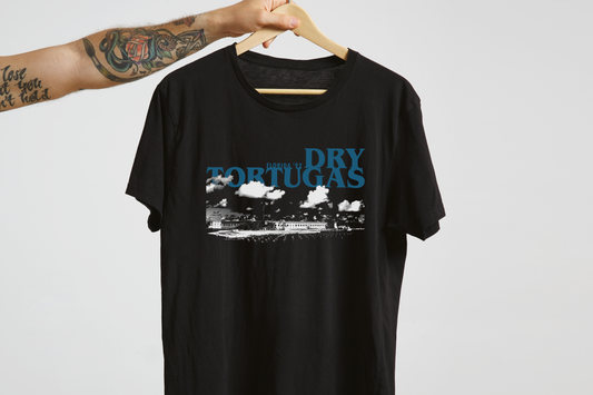 Black t-shirt with 'Dry Tortugas' graphic design on a hanger against a light gray background