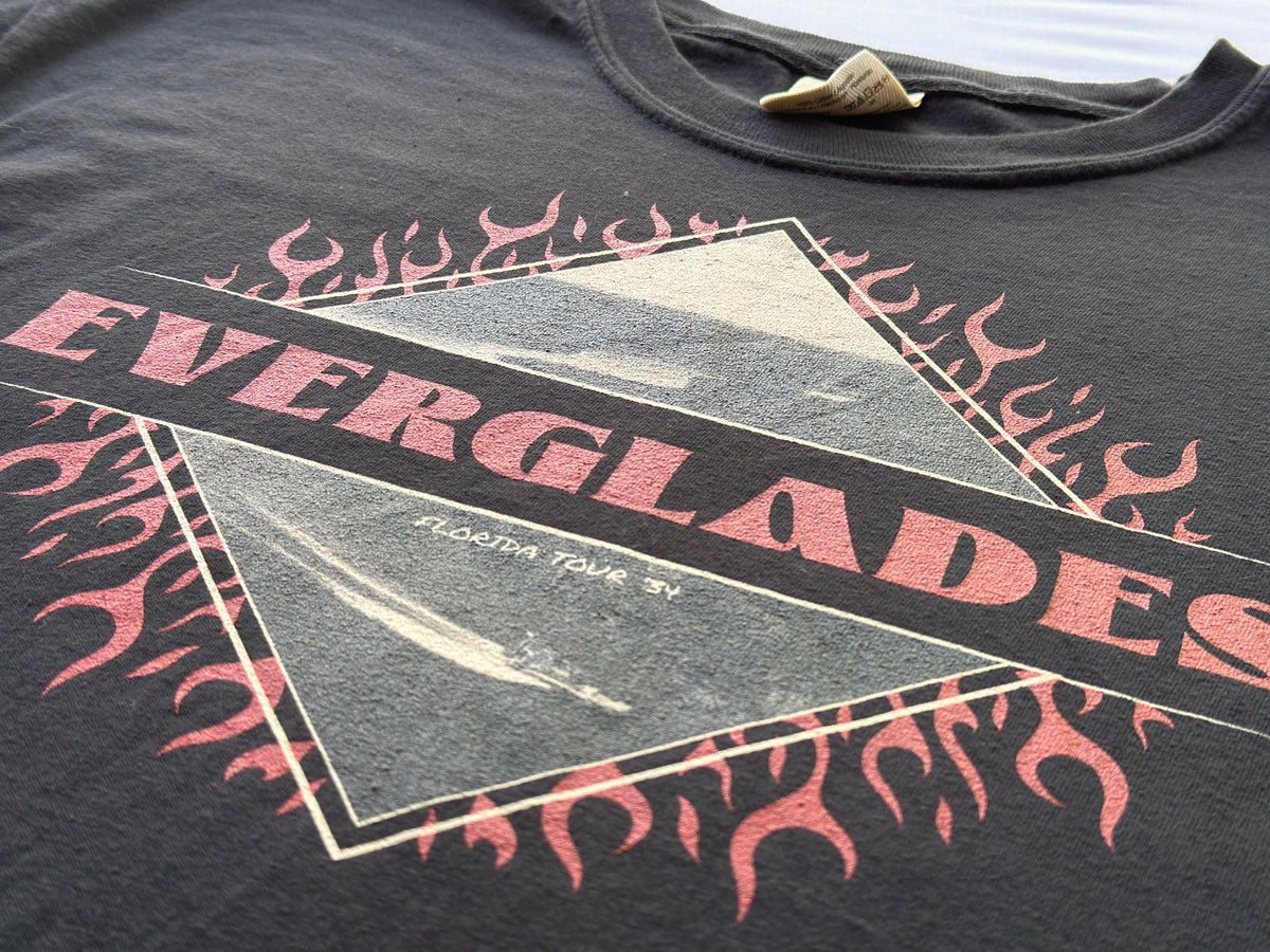 Black t-shirt with pink and white graphic design featuring 'Everglades' text and images.