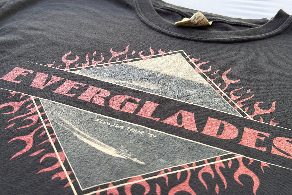 Black t-shirt with pink and white graphic design featuring 'Everglades' text and images.