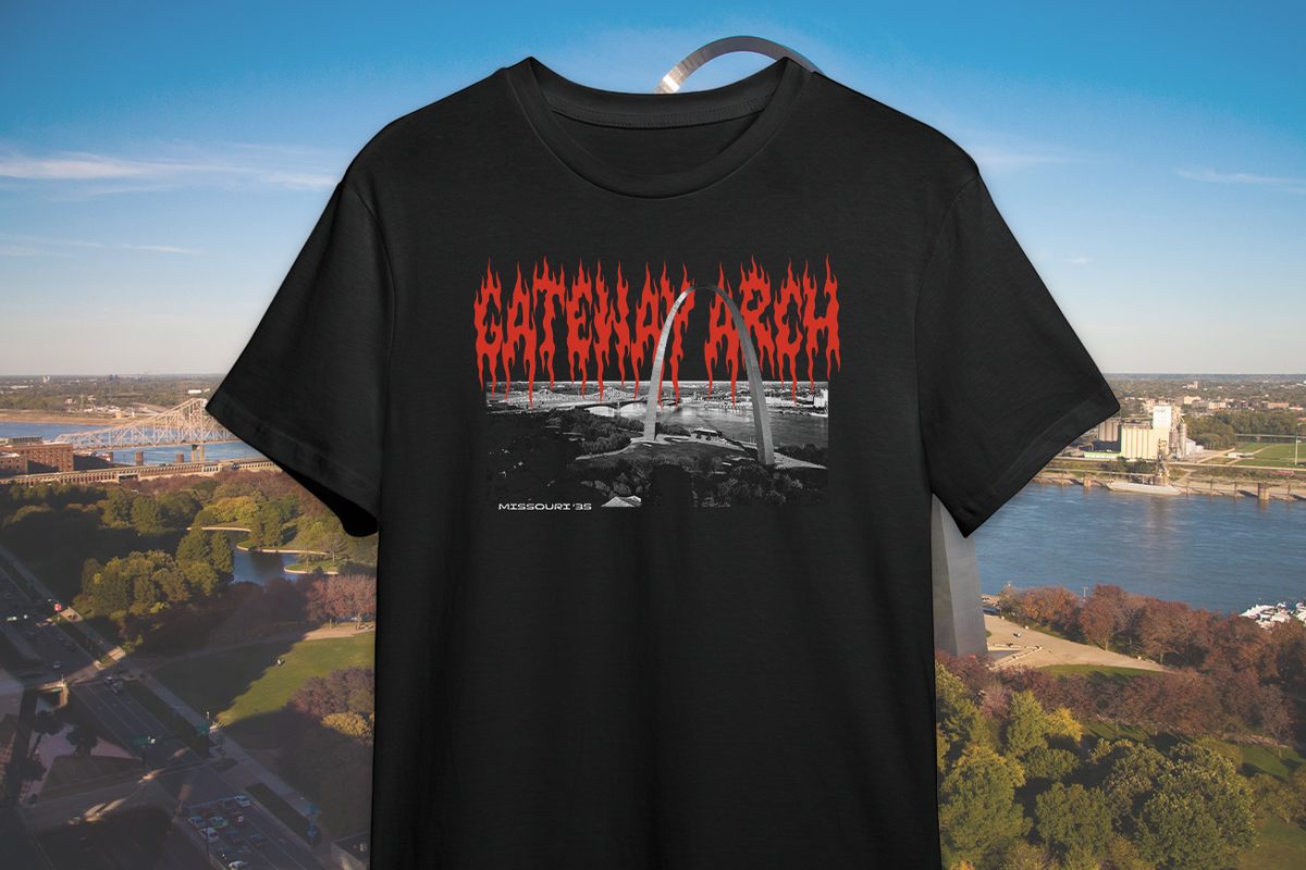 Black t-shirt with red text 'GATEWAY ARCH' against a cityscape background