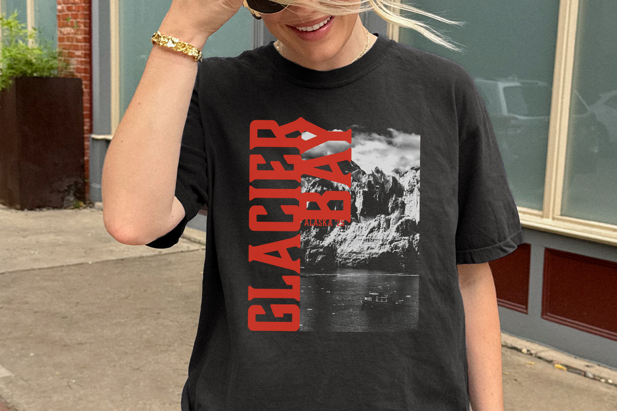 Person wearing a black t-shirt with 'Glacier Bay' graphic design.