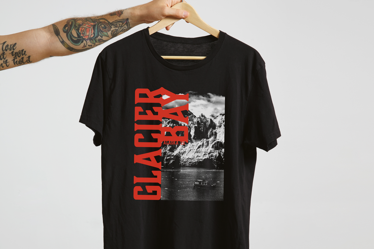 Black t-shirt with 'Glacier Bay' graphic design on a hanger against a white background