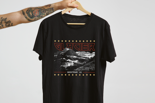 Black t-shirt with mountain graphic and 'Glacier' text on a hanger against a white background
