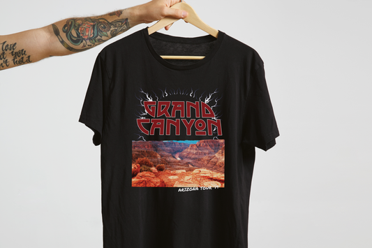 Black t-shirt with Grand Canyon graphic design on a hanger against a white background