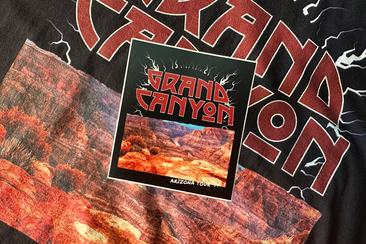 'Grand Canyon' sticker on a textured background.