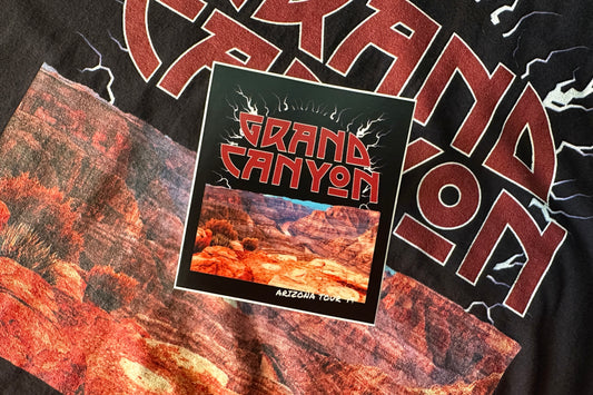 'Grand Canyon' sticker on a textured background.