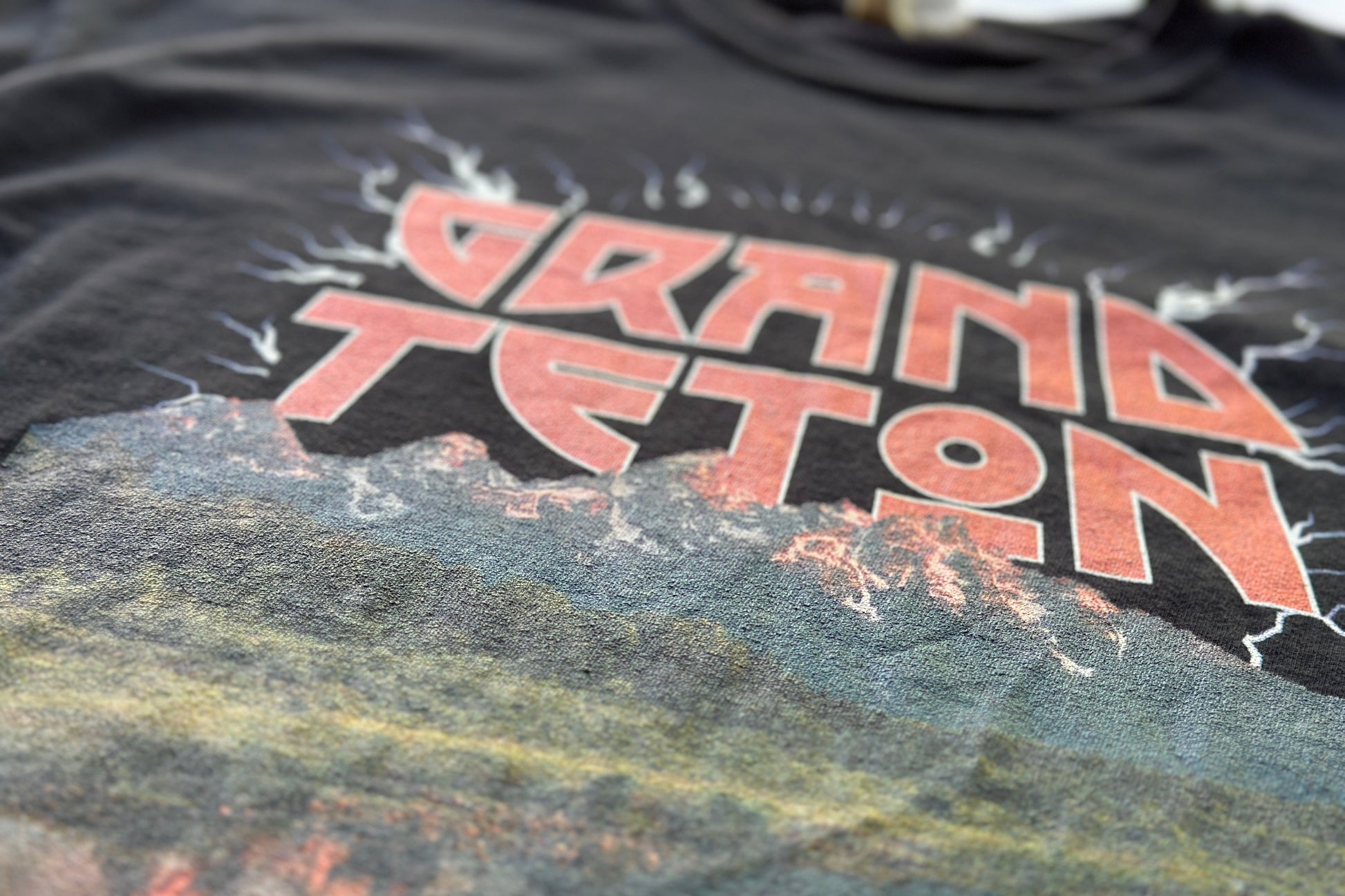 Black t-shirt with 'Grand Teton' printed on it, featuring a mountain graphic.