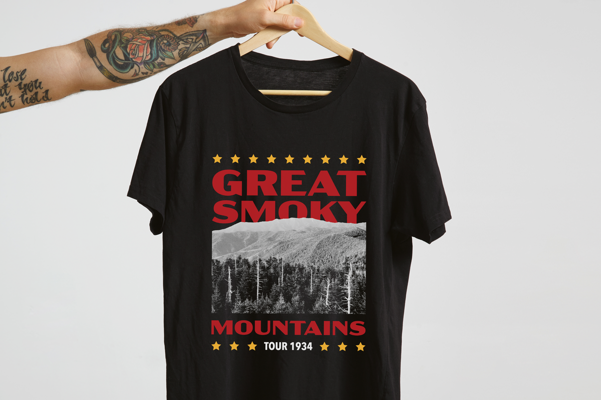 Black t-shirt with 'Great Smoky Mountains' design on a hanger against a light gray background