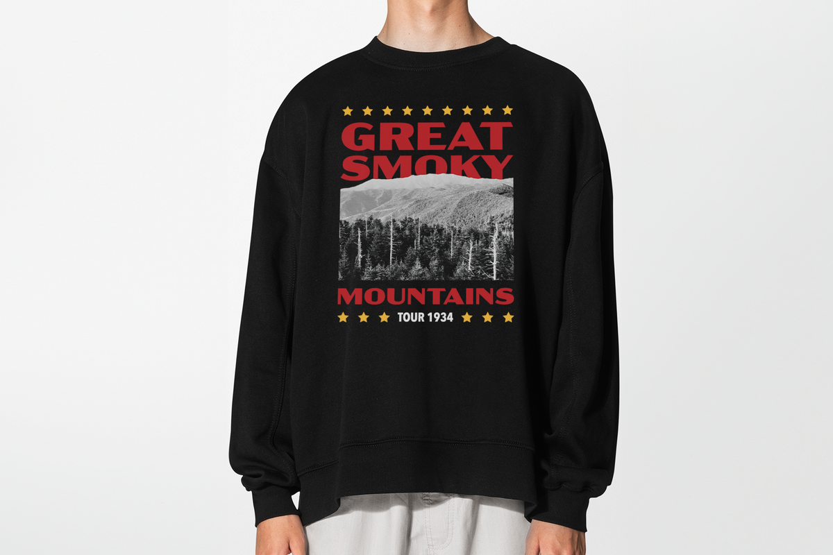 A person wearing a black sweatshirt with 'Great Smoky Mountains' design, in front of a white background