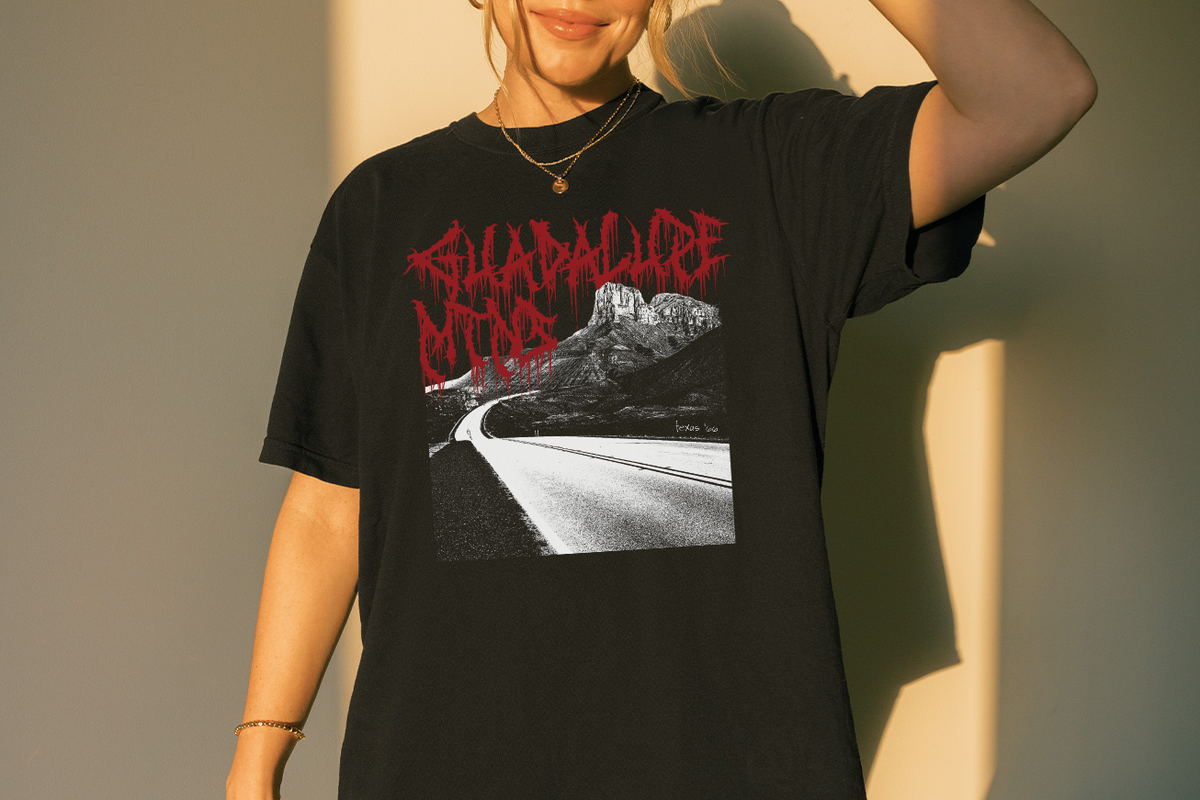 Person wearing a black t-shirt with 'Guadalupe Mountains' graphic design and text