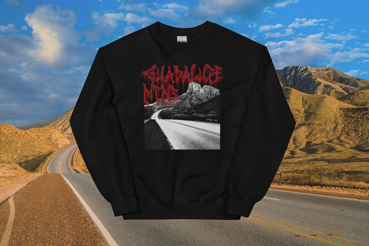Black sweatshirt with red 'Guadalupes Mountains' text and a road graphic on a scenic background