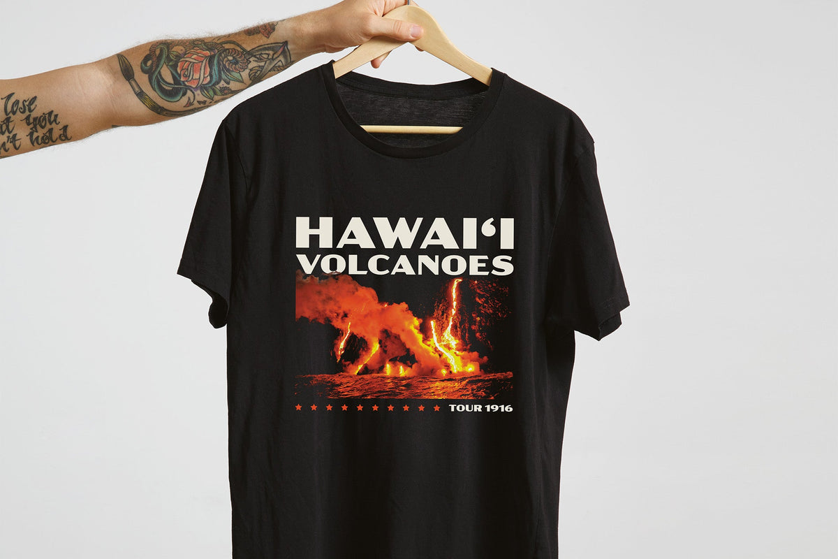 Black t-shirt with 'Hawaii Volcanoes National Park' graphic on a hanger against a white background
