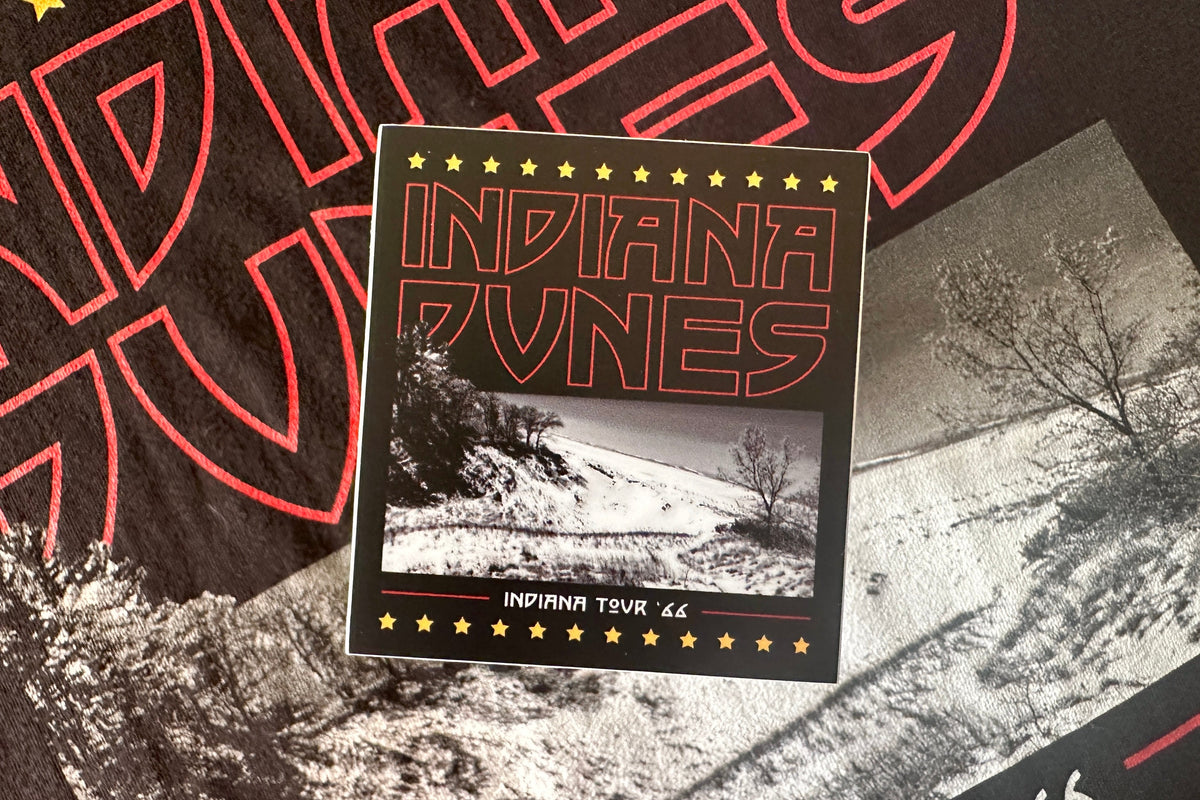 Sticker with a red and white 'Indiana Dunes' design, on a textured background