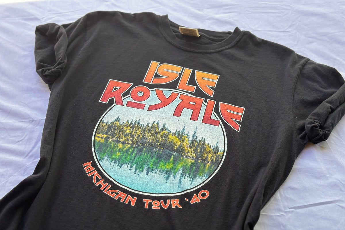 Black t-shirt with 'Isle Royale Michigan Tour 40' graphic design on a white background