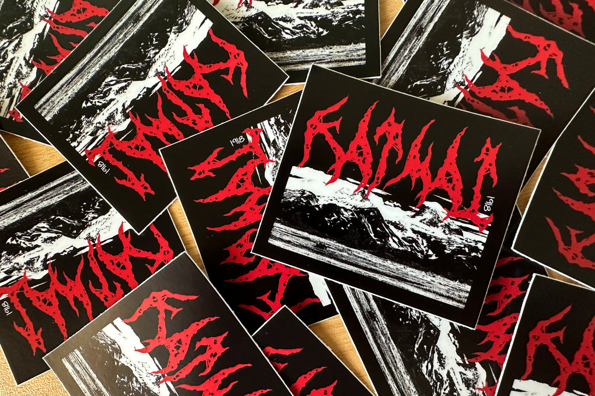 Stickers with red and black 'Katmai' design on a textured surface