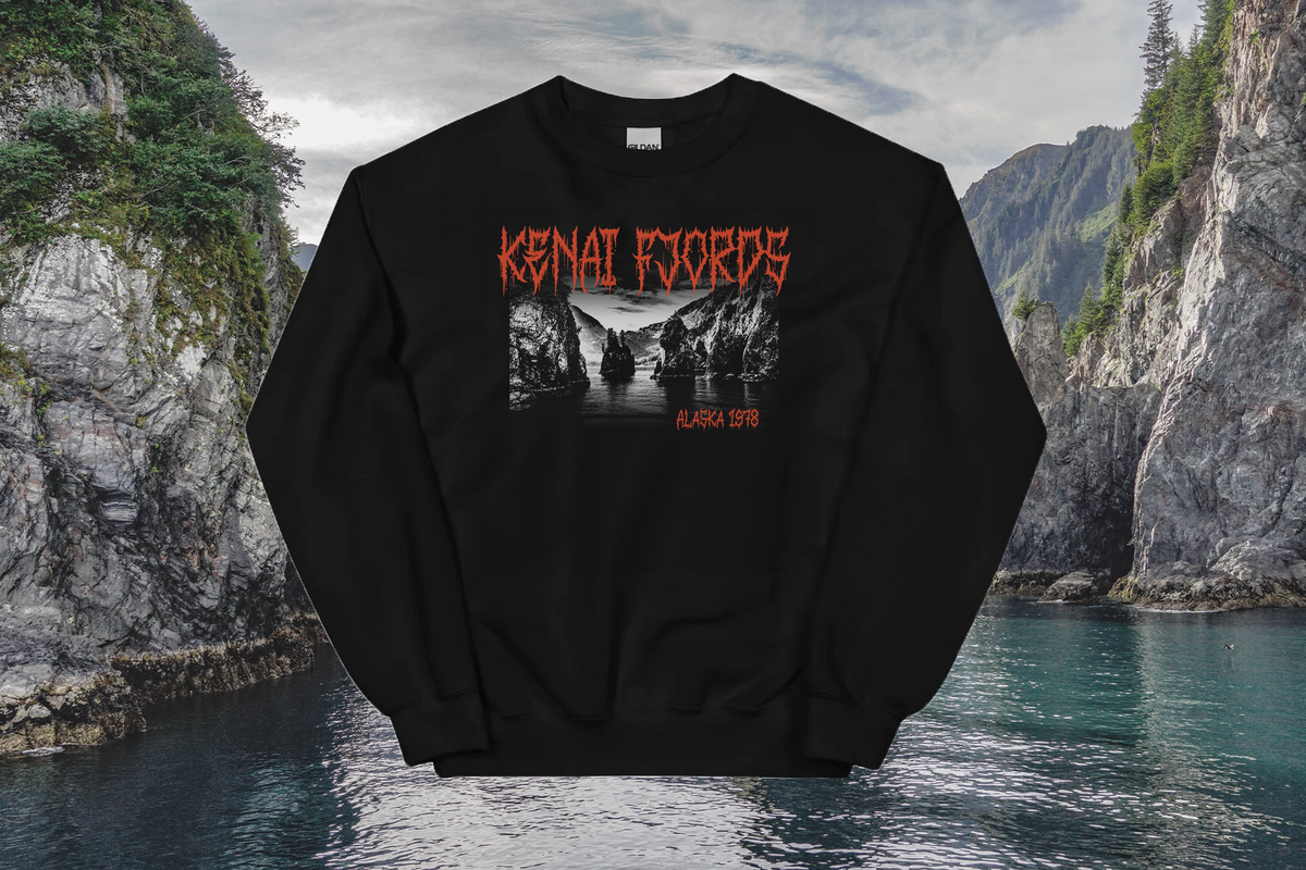 Black sweatshirt with 'Kenai Fjords' design in front of a scenic mountain landscape.