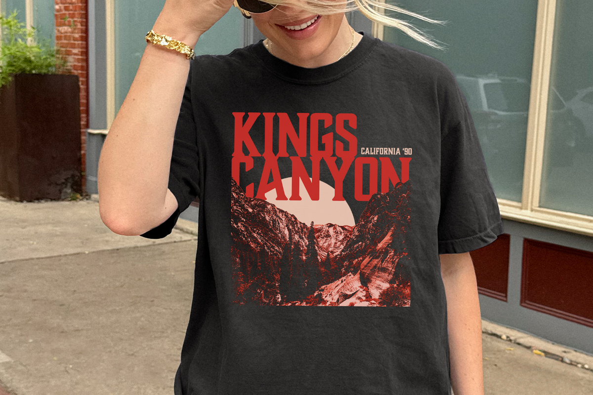 Person wearing a black t-shirt with 'Kings Canyon California' graphic design.