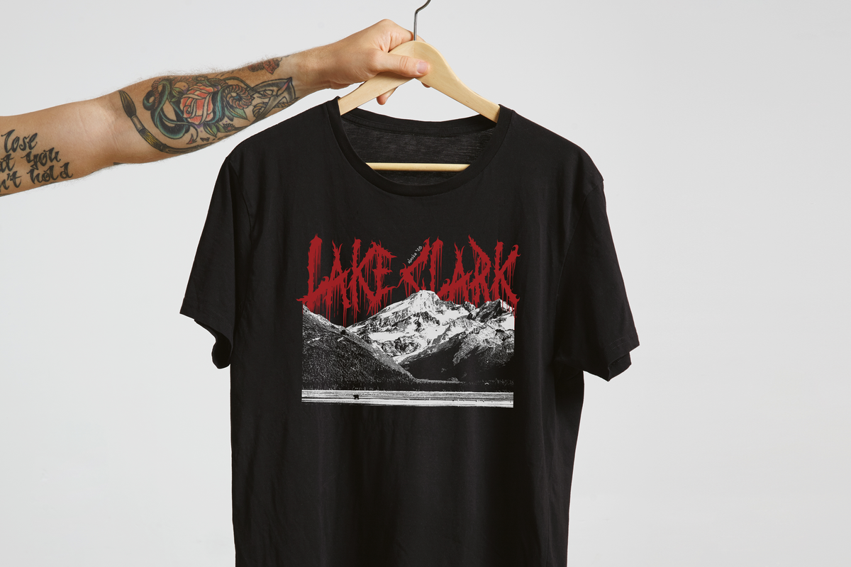 Black t-shirt with 'Lake Clark' graphic design on a hanger against a light gray background