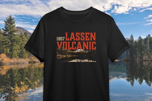 A black t-shirt with a red 'Lassen Volcanic' graphic design, in front of a scenic background