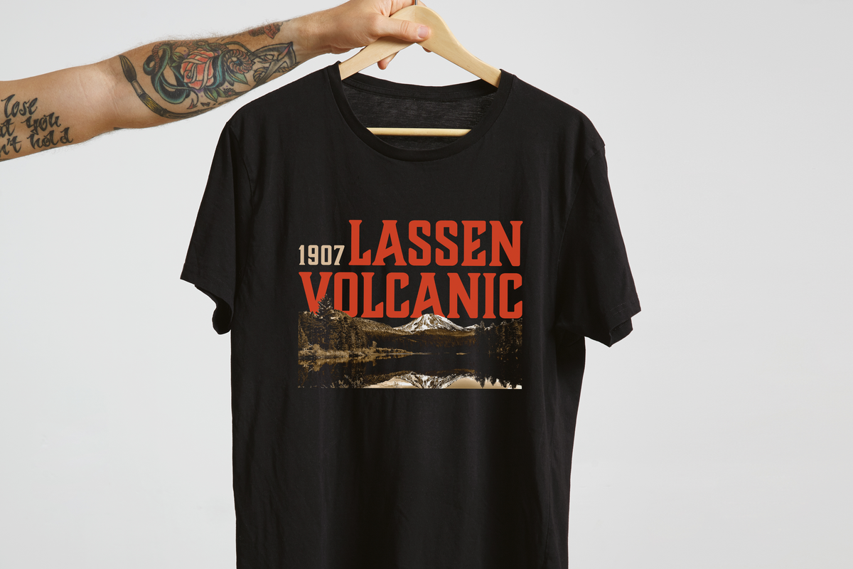 Black t-shirt with 'Lassen Volcanic' design on a hanger against a white background