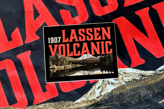Vintage-style sticker with 'Lassen Volcanic' text and mountain graphic on a textured background.