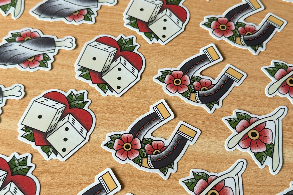Pattern of dice and horseshoe stickers on a wooden surface